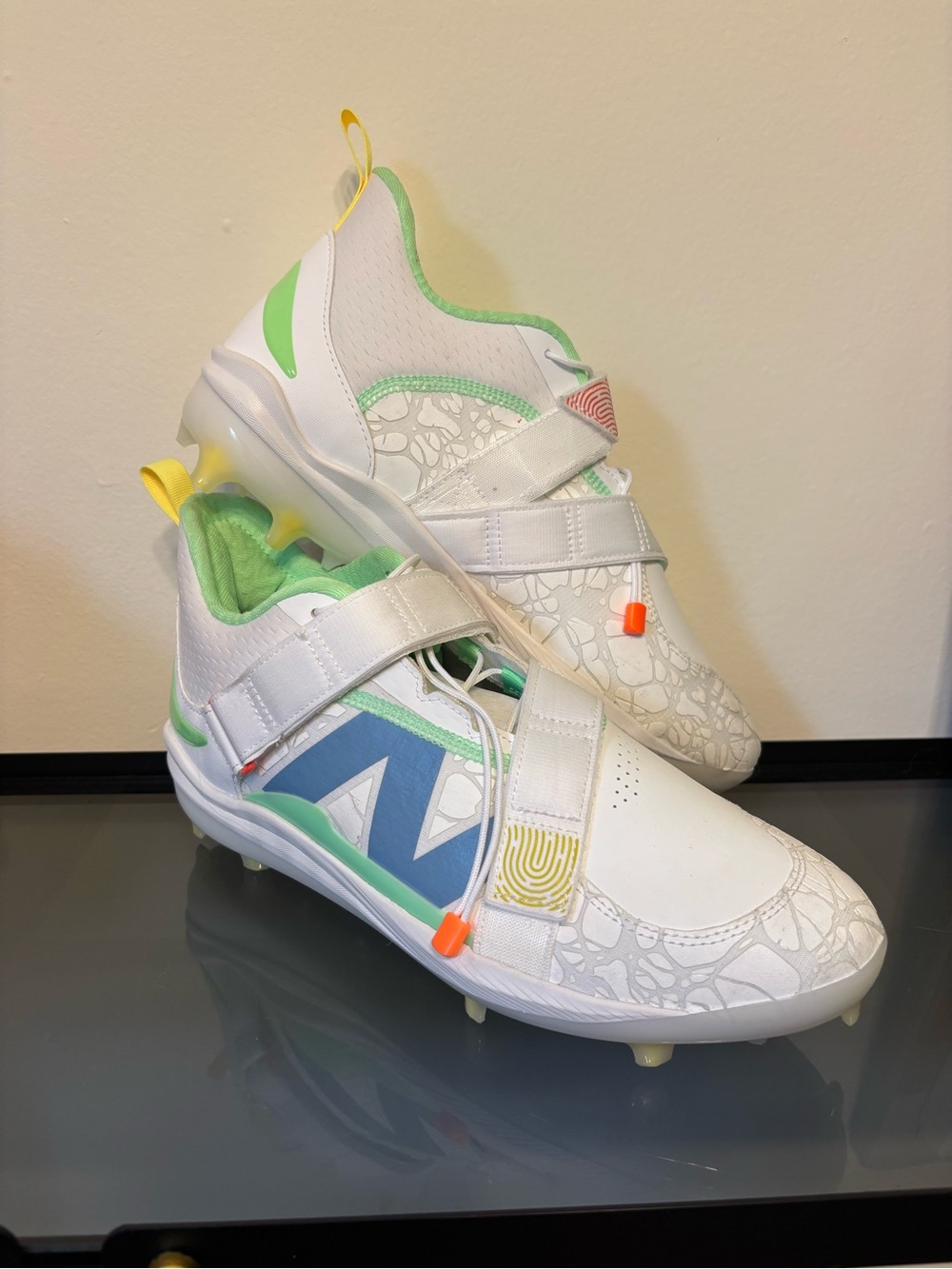New Balance White Kids Sneakers with Blue and Green Accents and Yellow Pull Tabs
